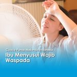 Seorang ibu menyusui terlihat kepanasan di depan kipas angin saat cuaca panas melanda Indonesia.